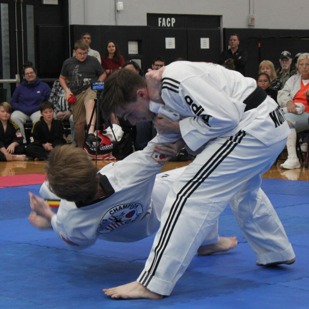 Kickboxing Thumbnail An adult student is performing a takedown technique on another student in class